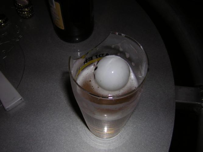 A glass of bier ... with a ping pong ball